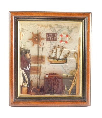 Nautical interest. A framed sea fishing diorama, with three masted sailing boat, lifebuoy, capstan wheel and fishing related and nautical effects, in fitted glazed case, 36cm x 31cm.
