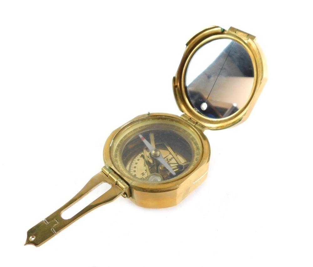 A Stanley London brass nautical compass, with Natural Sine table to the  outer casing.