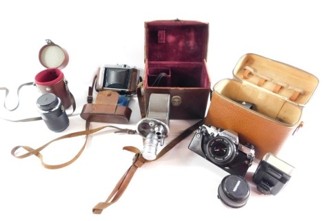 A group of camera equipment, comprising Karl Zeiss Jena Zoom II lens, f+70-210mm, an Olympus AM10 camera, a Miranda 28mm lens, flash, Bell & Howell Viceroy cine camera, and a Voigtlander camera with a 1:4,5/80 lens. (a quantity)