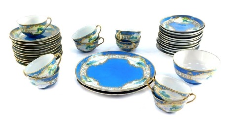 A Japanese L & Co Nippon porcelain part tea service, decorated with landscapes against a blue ground, gilt heightened, comprising pair of bread plates, sugar bowl, nine tea cups, twelve saucers and plates, some AF. (1 tray)