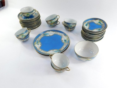 A Japanese L & Co Nippon porcelain part tea service, decorated with landscapes against a blue ground, gilt heightened, comprising pair of bread plates, sugar bowl, nine tea cups, twelve saucers and plates, some AF. (1 tray) - 2