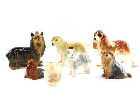 A Beswick Yorkshire Terrier, no 1944, a Sylvac Old English Sheep Dog, and a Yorkshire Terrier, further pottery figures of dogs, and a Royal Worcester porcelain commemorative blush porcelain cream jug . (7)