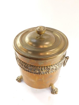 A brass coal box and cover, embossed with a band of mistletoe, on three lion's paw feet, 40cm high. - 2