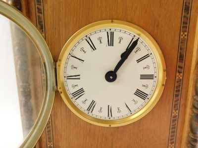 A late 20thC walnut cased mantel clock, circular dial bearing Roman numerals, clockwork movement with bell strike, the rectangular set top with swing handle, on turned column supports, and outer marquetry banding, on square set feet, 25cm high, 19cm wide, - 2