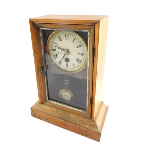 A late 19thC mahogany cased mantel clock, the circular enamelled metal dial bearing Roman numerals, thirty hour movement, the case of rectangular form with glazed front, pendulum drop, on a stepped base, with key, 30cm high, 22cm wide, 11cm deep.