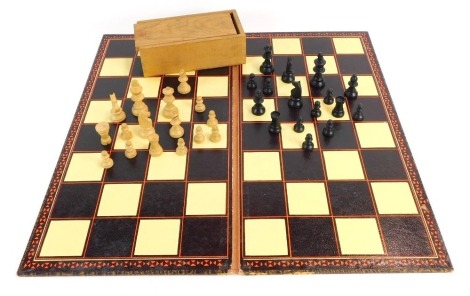 A Staunton type wooden chess set, in wooden case with chess and draughts board, bearing label for K&C Ltd. (2)