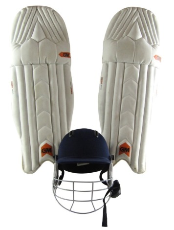 A pair of G M Hero 606 cricketing knee pads, and a Dukes 2006 medium cricket helmet. (3)