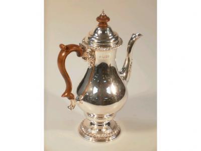 An Elizabeth II silver baluster chocolate pot with gadrooned edging with