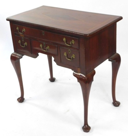 An Edwardian mahogany and satin wood banded lowboy, with one long drawer above one short, flanked by two deep short drawers, raised on cabriole legs, 77.5cm high, 80cm wide, 44.5cm deep.