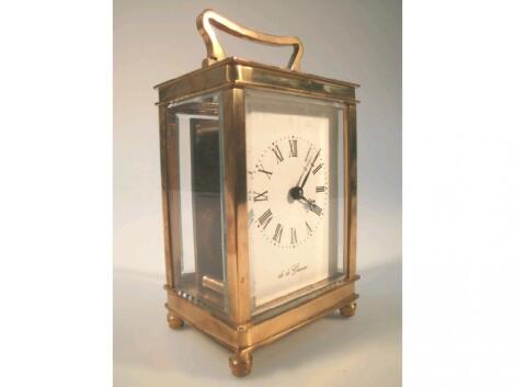 A modern brass carriage clock by De La Grense with plain enamelled dial