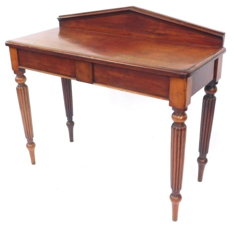 A Victorian mahogany hall table, with a triangular shaped back, above two frieze drawers, raised on turned and reeded legs, 100cm high, 113cm wide, 50cm deep.