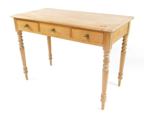 A Victorian pine side table, rectangular shaped top above three drawers, one false, raised on turned legs, 73cm high, 105cm wide, 52cm deep.