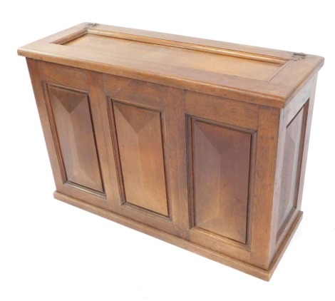 A 19thC oak hall cabinet, with hinged lid and triple panelled front, on a plinth base, 63cm high, 96cm wide, 33cm deep.