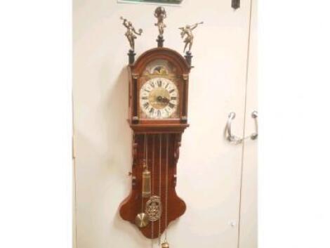 A modern reproduction wall clock with domed hood with three cast brass