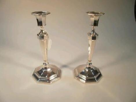 A pair of George V silver candlesticks by Hawkesworth Eyre & Co