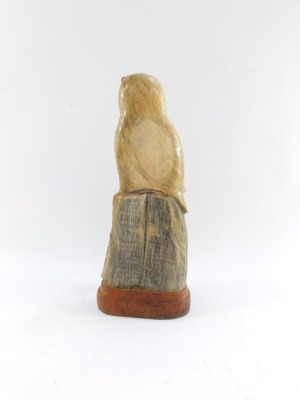 A carved horn figure of an owl on a perch, on wooden base, 26cm high. - 2