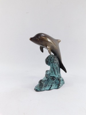 A bronze figure of a dolphin riding the crest of a wave, with blue patinated finish, 16cm high. - 2