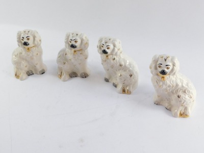 Four Royal Doulton figures of Staffordshire type flatback spaniels, each in white picked out in gilt, 14cm high. - 3