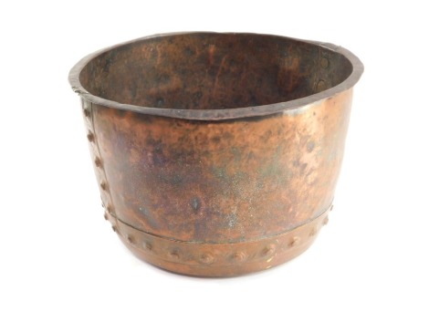 A hammered copper log bucket, with studded strap work, 30cm high, 50cm diameter.