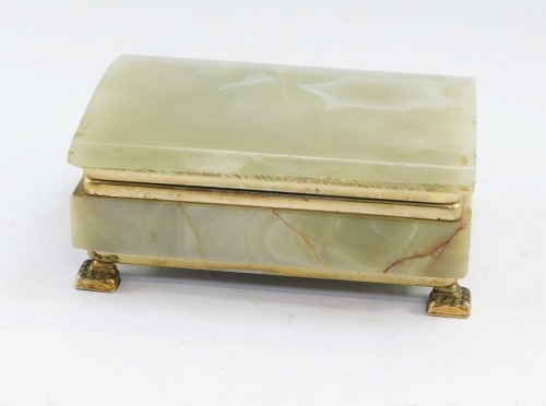 A 1970's Italian onyx and brass bound cigarette box, of domed rectangular form, 6cm high, 13cm wide, 10cm deep.