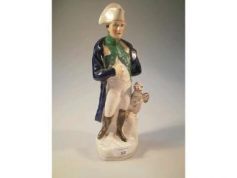 A Staffordshire portrait figure of Napoleon standing with Victory Eagle