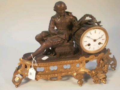 A late 19thC French ormolu and bronzed spelter mantel timepiece with a