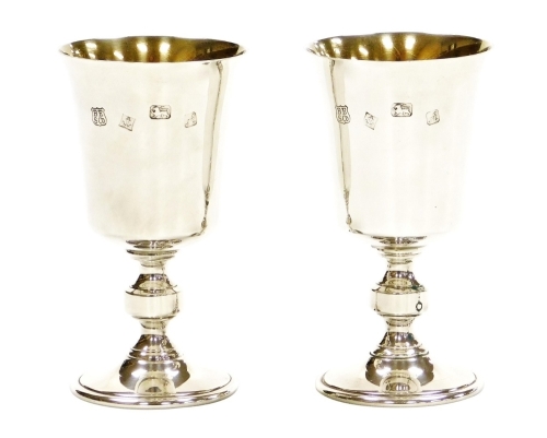 A pair of Elizabeth II silver goblets, with a plain bowl and knopped stem, Birmingham 1975, by Barker Ellis Silver Co, 9¾oz, 13cm high.