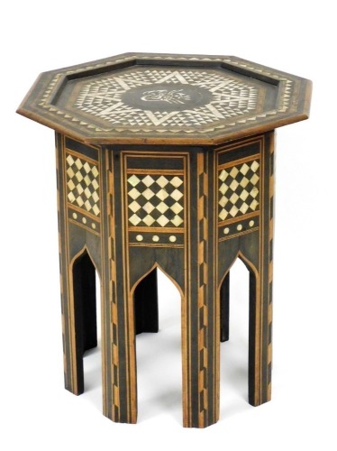 An early 20thC Anglo Indian hardwood occasional table, the octagonal top inlaid in mother of pearl within parquetry bands, the base with similar decoration in Liberty style, 54cm high, 51cm wide.