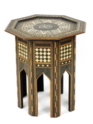 An early 20thC Anglo Indian hardwood occasional table, the octagonal top inlaid in mother of pearl within parquetry bands, the base with similar decoration in Liberty style, 54cm high, 51cm wide.