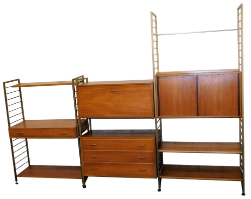 A group of Staples Ladderax shelving units, with gilt metal supports, in three sections, containing bureau, drawers, sliding doors and shelves, 201cm high, current set up approx 280cm wide.