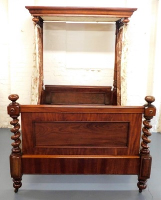 A Victorian mahogany half tester bed, the mahogany canopy with drop turned finals supported with lappet carved turned back posts, flanking a panelled headboard, the footboard with similar panelling and spiral turned supports with bun feet and castors, 225 - 2