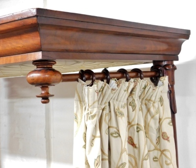 A Victorian mahogany half tester bed, the mahogany canopy with drop turned finals supported with lappet carved turned back posts, flanking a panelled headboard, the footboard with similar panelling and spiral turned supports with bun feet and castors, 225 - 3