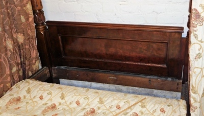 A Victorian mahogany half tester bed, the mahogany canopy with drop turned finals supported with lappet carved turned back posts, flanking a panelled headboard, the footboard with similar panelling and spiral turned supports with bun feet and castors, 225 - 4