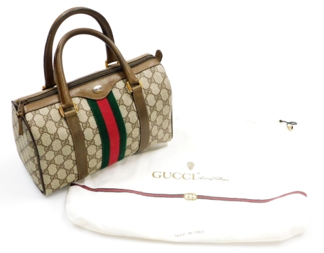 A vintage Gucci Ophidia canvas bowling bag, with brown leather trim and handles, the interior with a zipped compartment and Gucci Accessory Collection made in Italy label, serial number 52405/ 656495A, 19cm high, 27cm wide, 12cm deep, with dust bag.