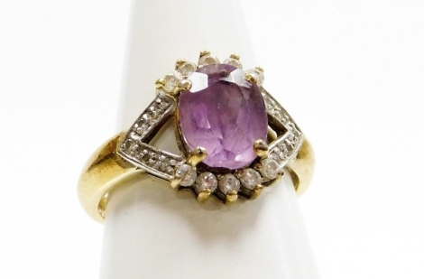 A silver amethyst and cubic zirconia set dress ring, the V splayed shoulders set with cz stones, surrounding a central amethyst, ring size N, 3.2g all in.