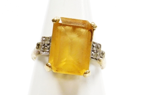 Withdrawn presale by vendor- A 9ct gold citrine and cubic zirconia set dress ring, the large rectangular central citrine in four claw setting, with Art Deco style shoulders, each set with cz stone, ring size P, 4.3g all in.