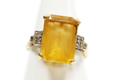 Withdrawn presale by vendor- A 9ct gold citrine and cubic zirconia set dress ring, the large rectangular central citrine in four claw setting, with Art Deco style shoulders, each set with cz stone, ring size P, 4.3g all in.