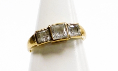 A 9ct gold three stone dress ring, set with three ash cut czs, in rub over setting, on a plain band, ring size P½, 2.6g all in.