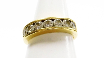 Withdrawn presale by vendor- An 18ct gold diamond half hoop dress ring, set with seven tension set graduated round brilliant cut diamonds, totalling 1ct, ring size N, 4.3g all in.
