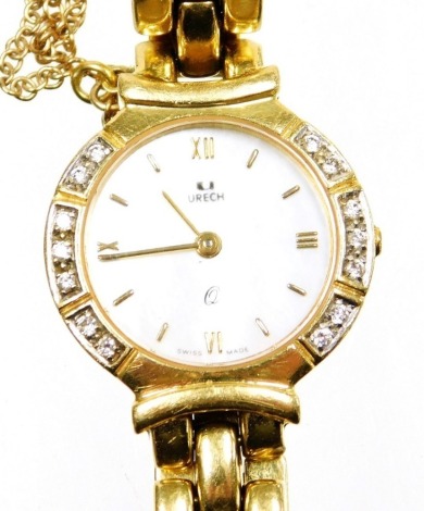 A Urech 18ct gold lady's wristwatch, the mother of pearl dial with Roman numerals, and outer set arrangement of tiny diamonds, on a three bar bracelet with safety chain, stamped 18k 750, and numbered 25125.9, the watch head 2cm wide, 39.2g all in.