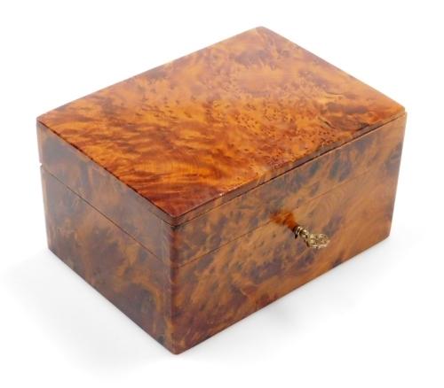 A walnut jewellery casket, the domed top opening to reveal a two level interior, 9cm high, 17cm wide, 12cm deep.