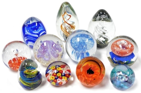 A group of glass paperweights, mostly Chinese, variously decorated. (11)