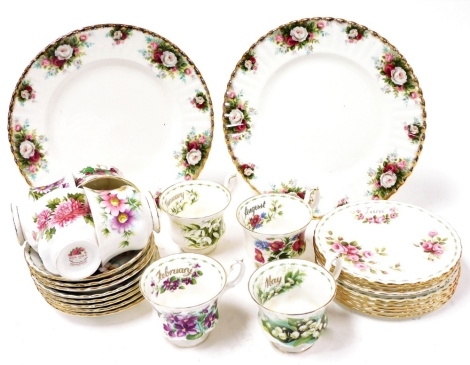 A Royal Albert porcelain part tea service decorated in the Flower of The Month series, comprising eight teacups, saucers, and nine plates, together with a pair of Celebration pattern dinner plates. (a quantity)