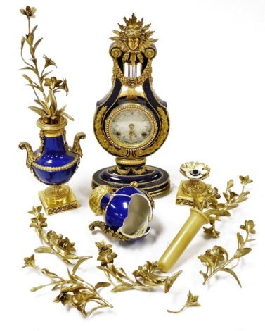 A Franklin Mint Marie Antoinette clock, the circular calendar dial bearing Roman numerals, eight day movement with bell strike, the case of lyre form surmounted by the emblem of Louis XIV, for the V and A, 39cm high, together with a pair of Marie Antoinet