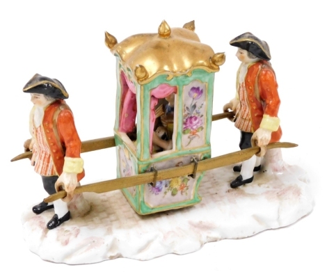 A 20thC Continental porcelain figure group, modelled as a lady in a sedan chair, modelled holding a dog and fan, being pulled by two attendants, raised on a naturalistic base, blue cross swords mark, 17.5cm wide.