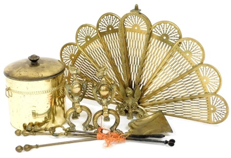 A brass and cast iron three piece fireside companion set, fan shaped mesh fire guard, a brass on tin coal bucket, and a pair of brass andirons.