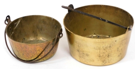 Two graduated brass jam pans, with cast iron handles.