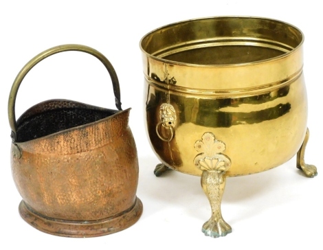 A brass log bucket, with lion's head and ring handles, raised on three cabriole legs and paw feet, 46cm high, together with a copper and brass helmet shaped coal scuttle. (2)