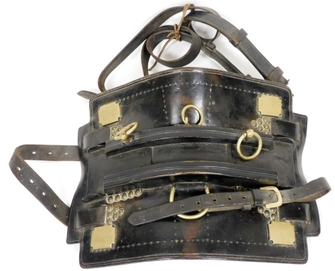 An early 20thC leather heavy horse, with brass mounts and studwork.