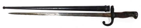 A late 19thC St Etienne bayonet, engraved to the blade Mre D'Armes de Chat, June 1876, number 10505, with scabbard.